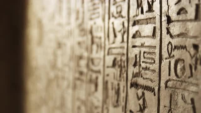 Focus pull on Egyptian hieroglyphs in Amarna's North Tombs, Egypt