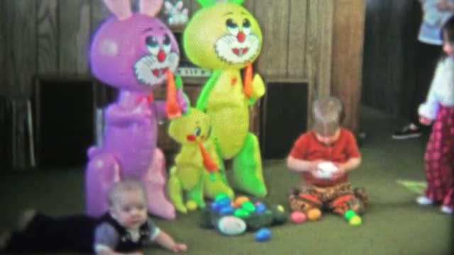 BOULDER, CO. USA - 1974: Boy attacks Easter egg candy and eats the chocolate.