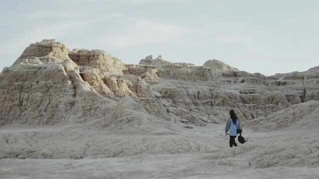 Girl Hiking In Badlands Long Shot
