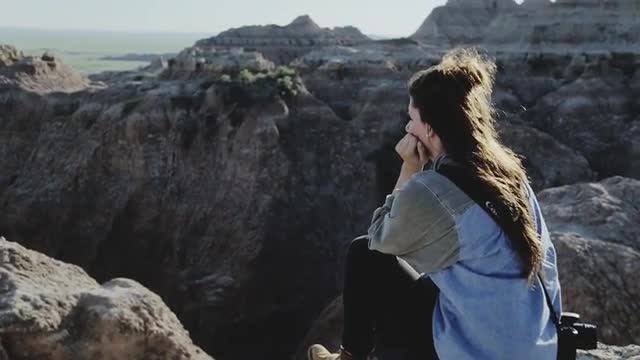 Girl Sitting In Badlands