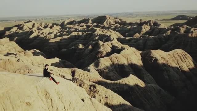 Young Man Sitting In Badlands