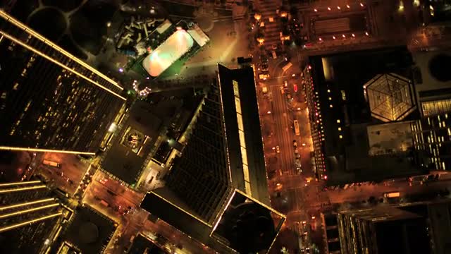 Aerial vertical view at night of city traffic illuminated by city streets, USA