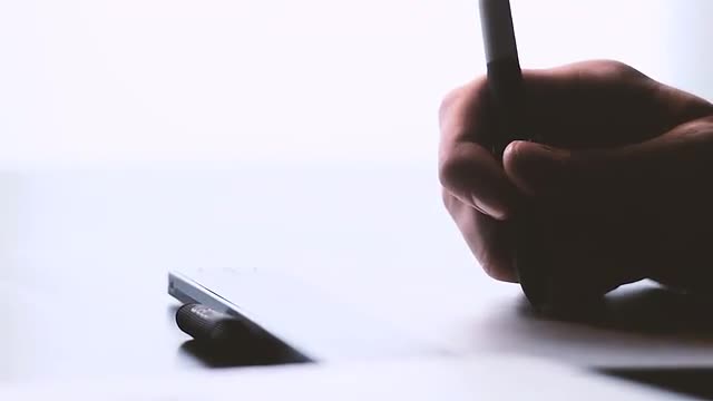 Digital Artist Writing on Tablet
