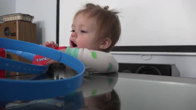  Rascal baby getting into trouble pulling out pieces of a game.