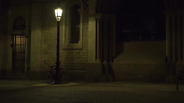 4K UHD shot of a bike at night in Barcelona streets