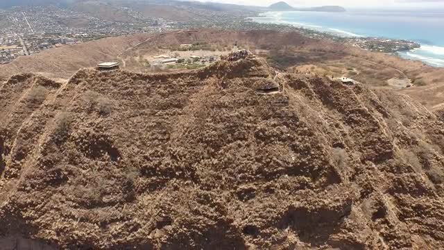 Flight over dry Diamond Head during the day. 