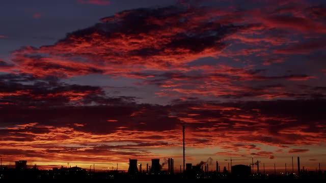 Sunset over the cooling towers and refining complex of Scotland's only oil refinery