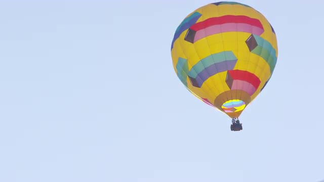 Hot Air Balloon Floats on the Right Side of Frame