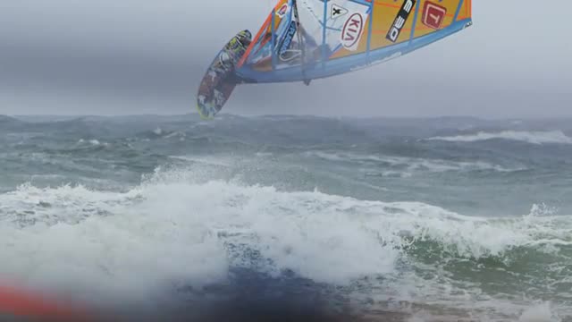 Windsurfer doing one footed backloop