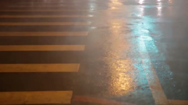 Heavy rain on pedestrian crossing during typhoon