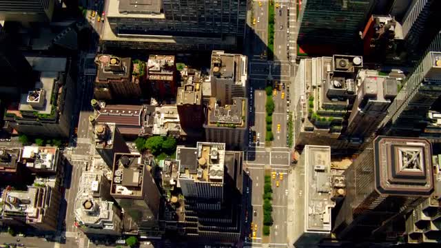 AERIAL OVERHEAD over rooftops of office buildings and light traffic on Park Avenue