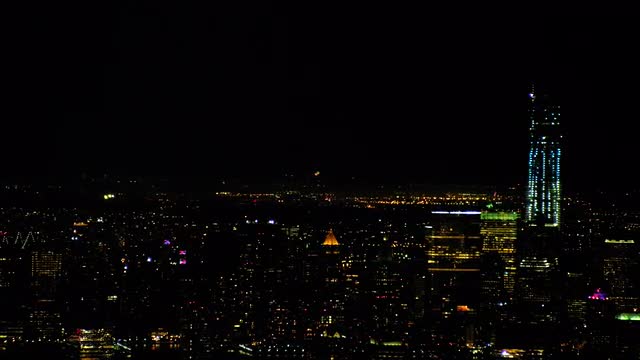 LONG AERIAL fireworks in New Jersey with downtown Manhattan in foreground 
