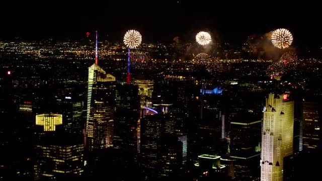 AERIAL fireworks with Midtown Manhattan in foreground at night