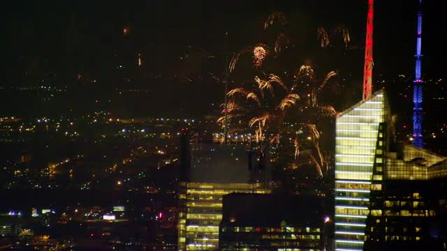 CLOSE UP AERIAL skyscrapers in Midtown Manhattan with fireworks in background