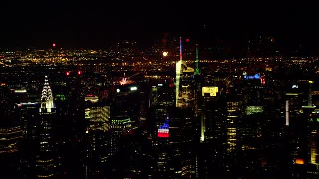CLOSE UP to WIDE AERIAL fireworks over Hudson River with Midtown Manhattan in foreground at night