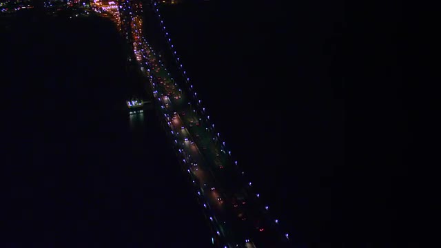 WIDE to MEDIUM AERIAL lit George Washington Bridge at night