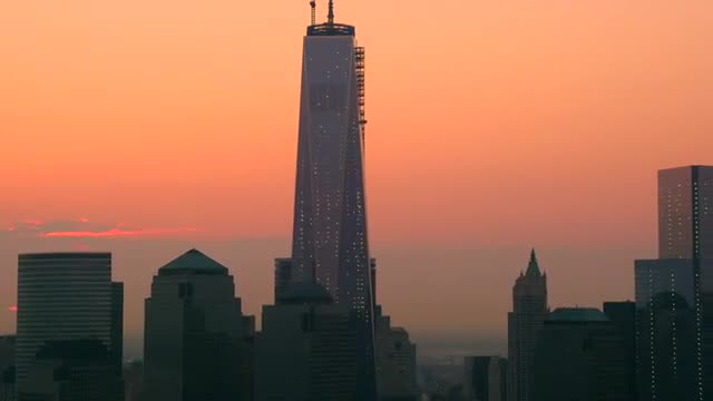 ZOOM IN from WIDE to MEDIUM AERIAL of buildings in Financial district at twilight