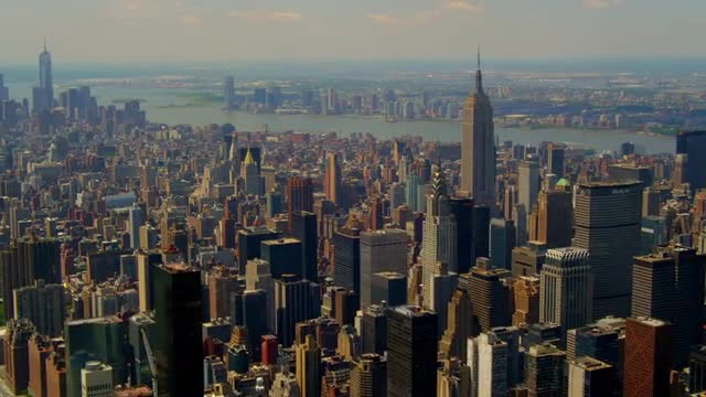 WIDE AERIAL POV with PAN over Midtown Manhattan East looking toward downtown