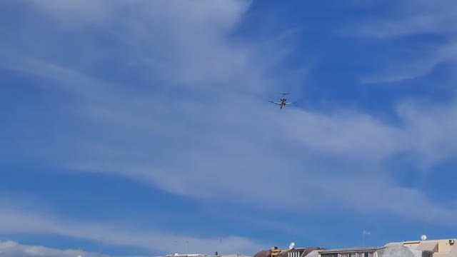 Aircraft flies over the houses. Ostia, Italy