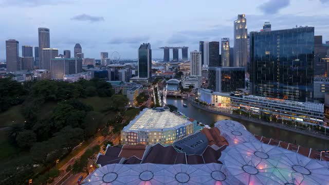  Elevated dusk to night view over the Entertainment district of Clarke Quay, the Singapore river and