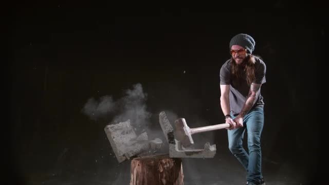 Man smashing cement block with hammer in slow motion, shot on Phantom Flex 4K at 1000 fps