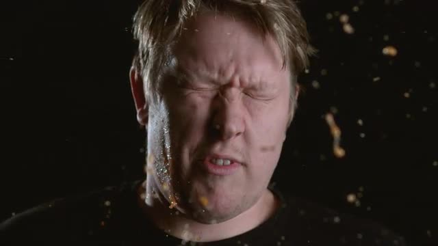 Slow motion shot of tomato hitting man in face, shot on Phantom Flex at 2000 fps