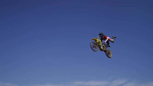 Motocross rider going off big jump, slow motion, 4K shot on RED Epic