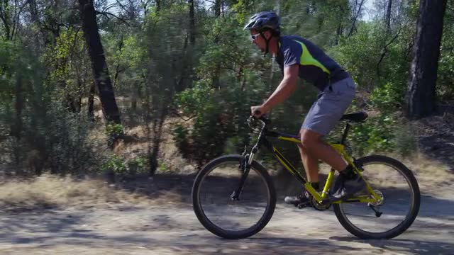 Man riding mountain bike in nature