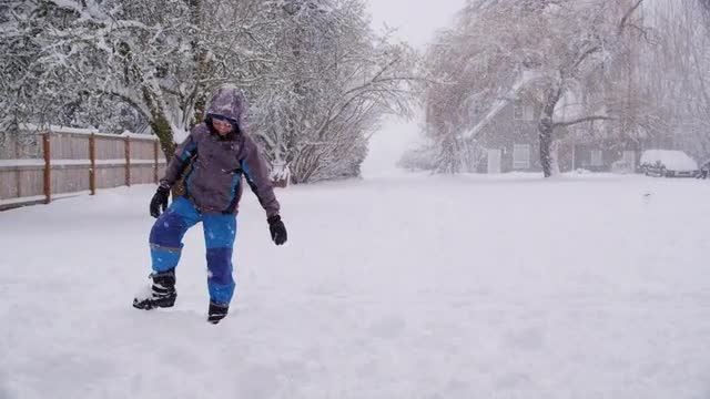 Boy throwing snow in winter