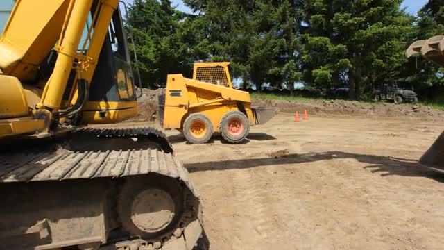 Construction workers work with excavation equipment