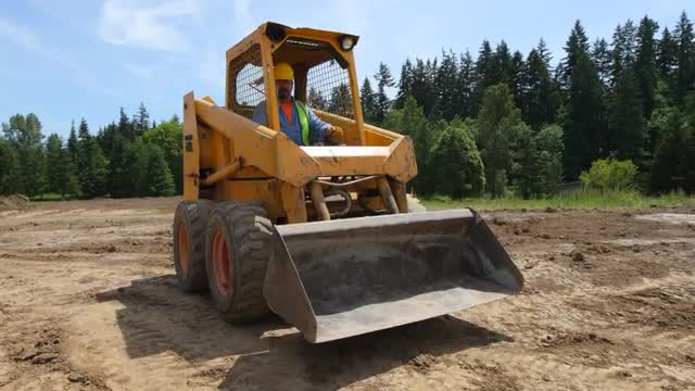 Construction worker driving excavation equipment