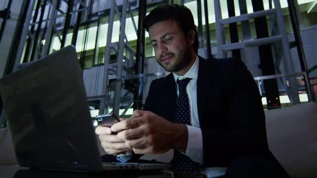 Arabic business man UAE real estate night office technology laptop smart phone