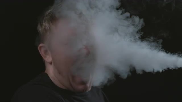 Smoke blowing in mans face- slow motion; shot on Phantom Flex 4K at 1000 fps