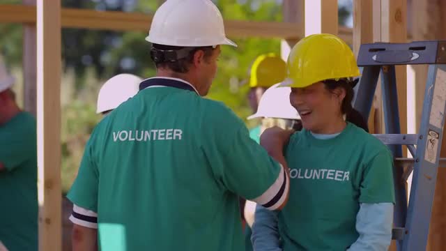 Volunteers working together on construction project