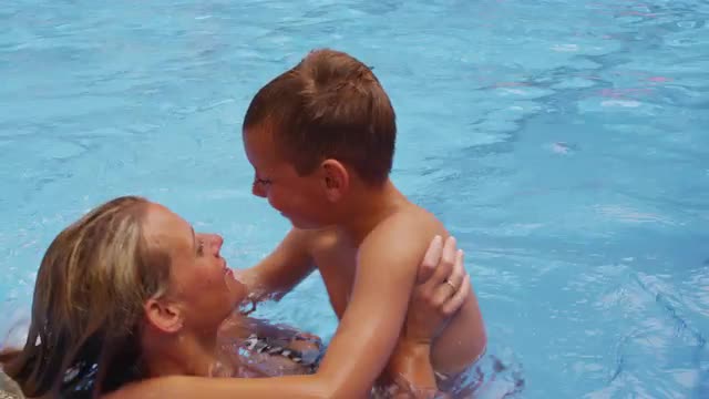 Mother and son playing in pool.  Shot on RED EPIC for high quality 4K, UHD, Ultra HD resolution.