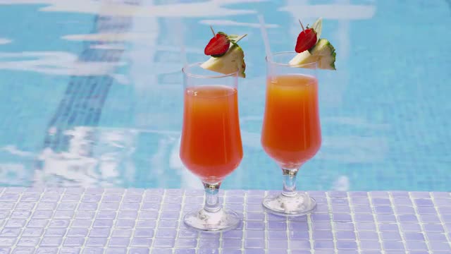 Two cocktails by pool . Shot on RED EPIC for high quality 4K, UHD, Ultra HD resolution.