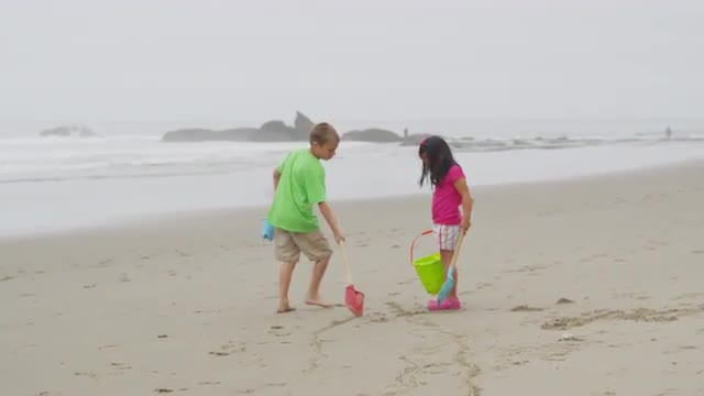 Children playing at beach. Shot on RED EPIC for high quality 4K, UHD, Ultra HD resolution.