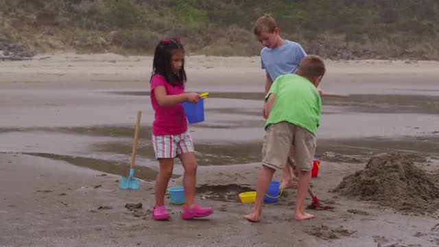 Children playing at beach. Shot on RED EPIC for high quality 4K, UHD, Ultra HD resolution.