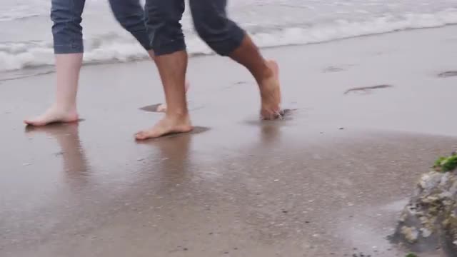 Couple walking at beach together. Shot on RED EPIC for high quality 4K, UHD, Ultra HD resolution.
