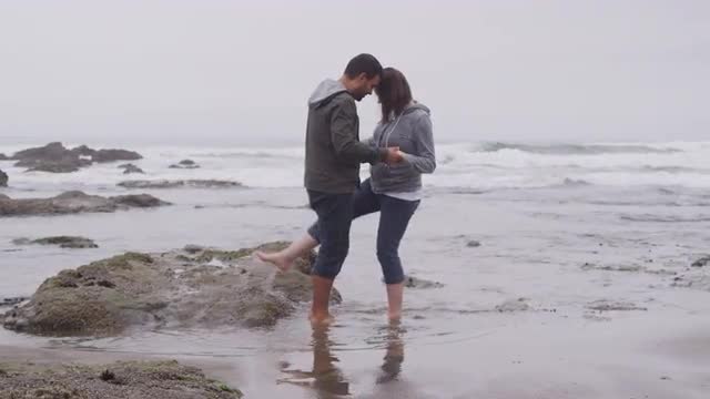 Couple walking at beach together. Shot on RED EPIC for high quality 4K, UHD, Ultra HD resolution.