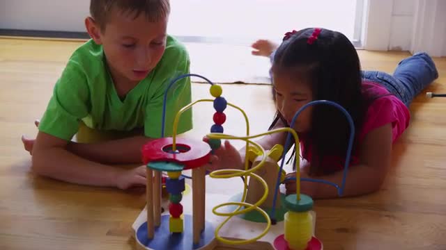 Young girl and boy playing with toy. Shot on RED EPIC for high quality 4K, UHD, Ultra HD resolution.