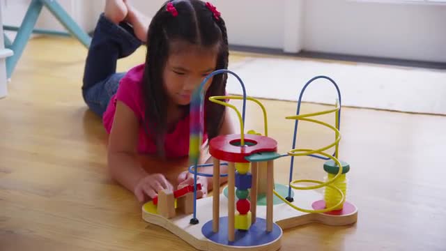 Young girl playing with toy. Shot on RED EPIC for high quality 4K, UHD, Ultra HD resolution.