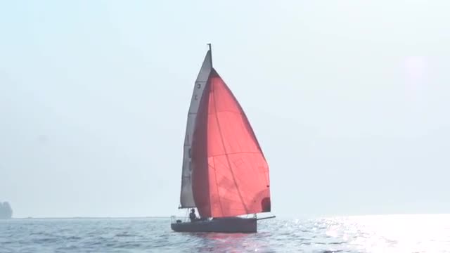 Red yacht sailing in the Arabian Sea