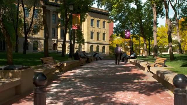 Cobblestone pathway leading to sandstone building 4K in Calgary