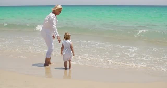 Grandmother and Little Girl Enjoying at the Beach