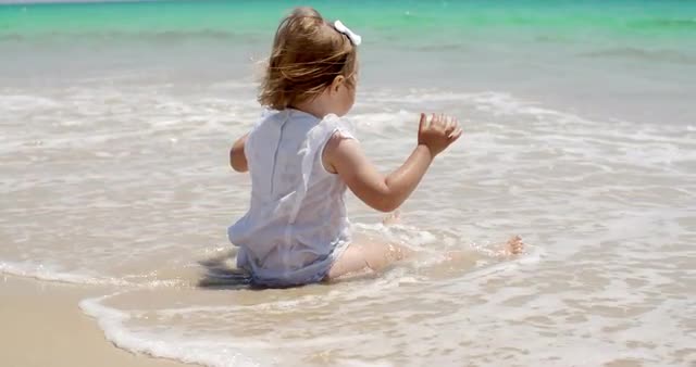 Cute Baby Girl Sitting on the Beach