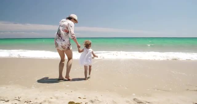Cute Girl With Mummy on The Beach