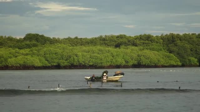 Men Prepare Boats at Anchor