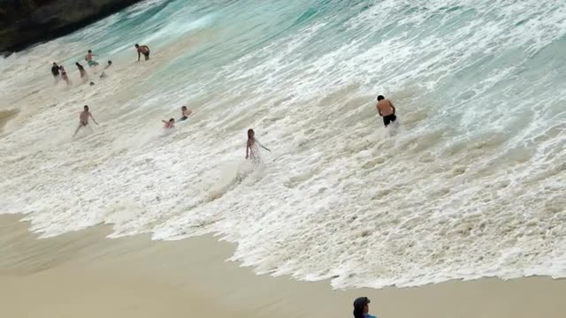 People Play in the Balinese Surf 