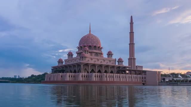 Sunrise Time Lapse at a Mosque by a Lake. Left to right pan.